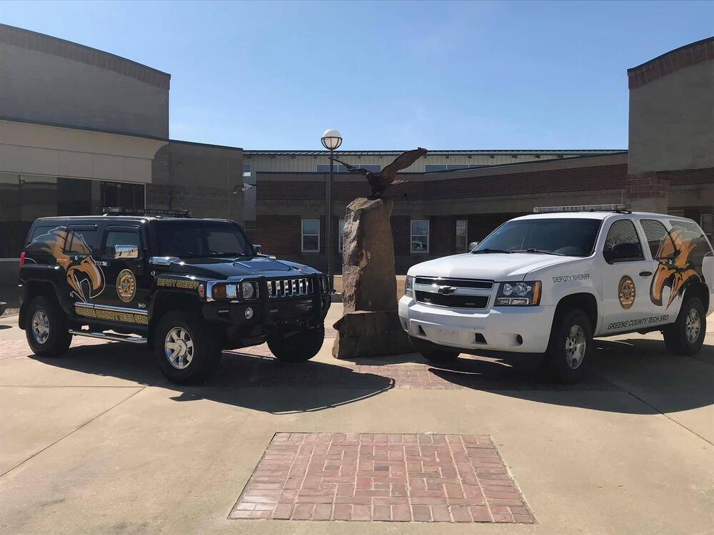 2 Sheriff vehicle parked in front of school